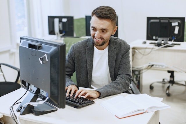 a man working a desktop computer in Petrie Terrace