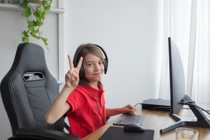 A boy use a desktop computer in an office in Petrie Terrace